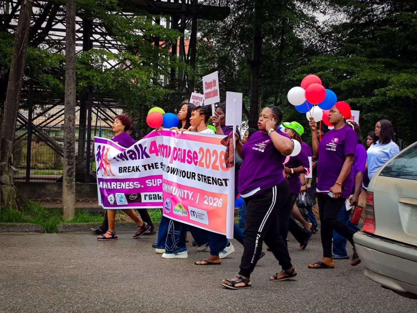 Walkers with balloons and the iWalk4Menopause banner